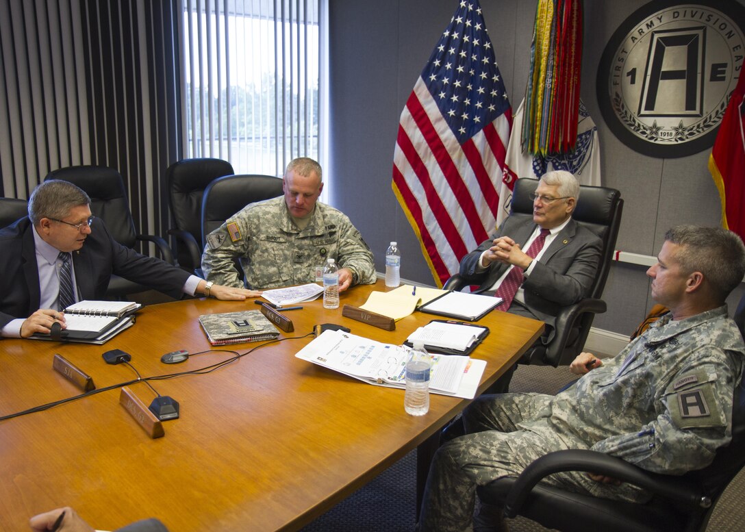 (left to right) Rickey Smith, staff director for the National Commission on the Future of the Army; Army Col. Michael Shrout, 1st Army Division East operations officer; Retired Army Gen. Carter Ham, NCFA; and Army Col. Tim Newsome, 1st Army Division East chief of staff discuss reserve component training July 14, 2015, at Fort Meade, Md. The commission is tasked with making recommendations concerning component roles, force structure design, organization, employment and reserve forces policy. (U.S. Army Reserve Photo by Sgt. 1st Class Jacob Boyer/RELEASED)