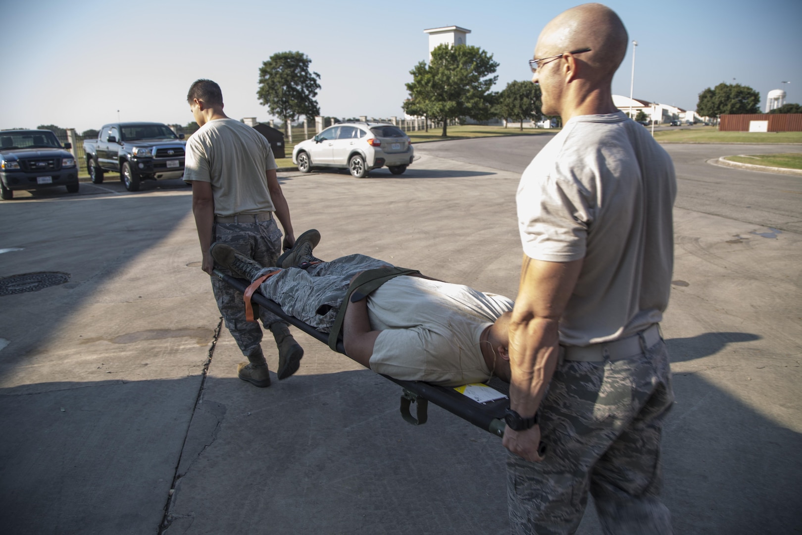 Staff Sgt. Allen Roby (left) and Staff Sgt. George Dowling (right), 502nd Civil Engineer Squadron firefighters, carry a fake triage victim on a litter during a training session Oct. 1 at Joint Base San Antonio-Randolph. Triage techniques are one of the many subjects 502nd CES firefighters train in, including rope rescue, dispatch control and hazardous material operations.