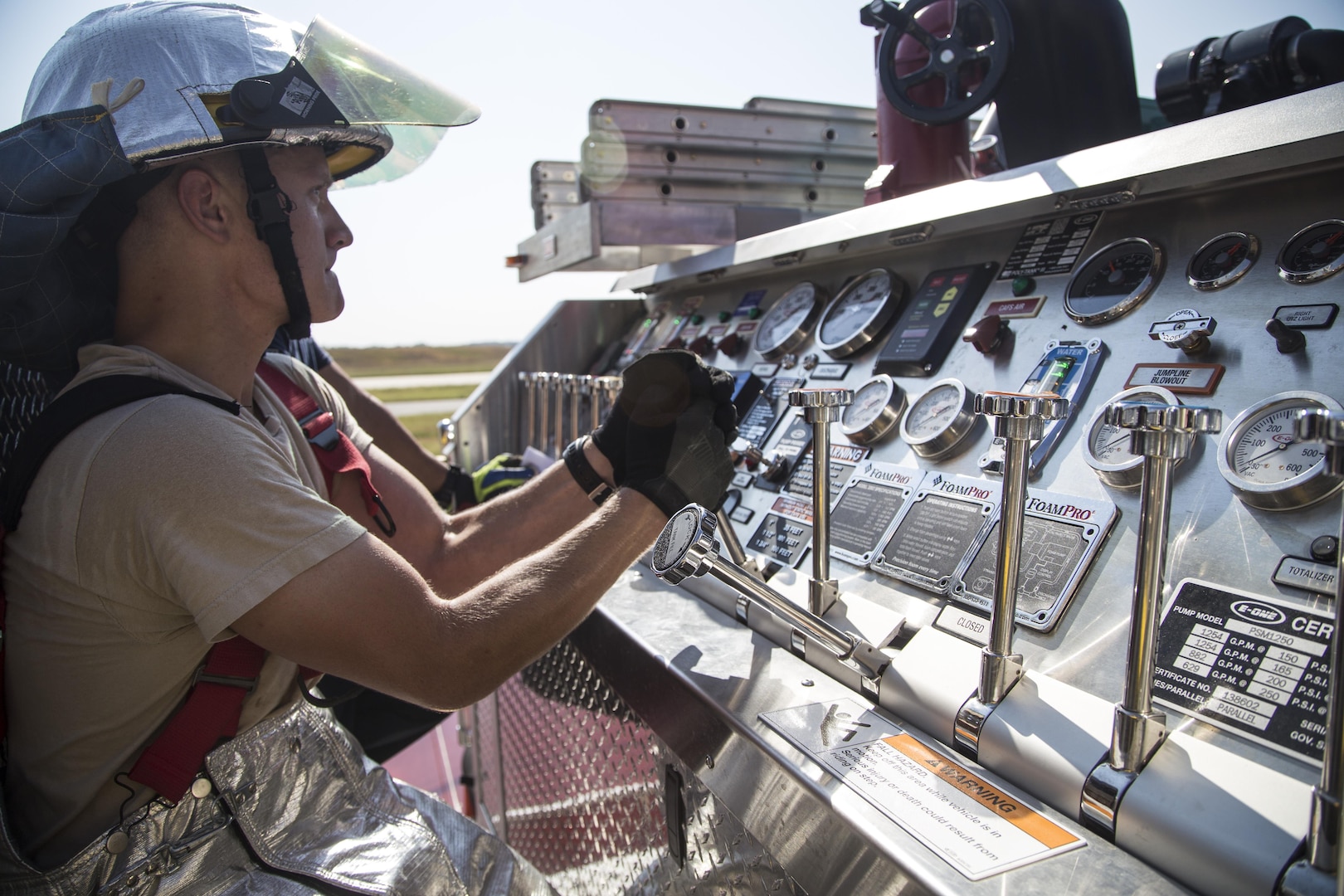 Airman 1st Class Brett Anderson, 502nd Civil Engineer Squadron firefighter, shifts the hydraulic levers to adjust water pressure on a fire truck during training Oct. 1 at Joint Base San Antonio-Randolph. The core missions of 502nd CES firefighters are to protect their team, others, property and the environment while responding to aircraft, structural and medical emergencies.