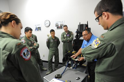 Ray Gutierrez (second from right), 12th Operations Support Squadron Aircrew Flight Equipment instructor, teaches 435th Flying Training Squadron students on T-38 egress Oct. 1 at Joint Base San Antonio-Randolph.