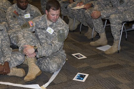 Soldiers in the Equal Opportunity Leaders Course are tasked to play a game in which they are forced to make critical decisions based on the face-value of a person July 15, 2015, at Farmingdale, N.Y. The EOLC is designed to provide leaders at battalion and company levels the critical skills needed to assist commanders, military personnel and family members with all the matters concerning equality and diversity in the organization. (U.S. Army Reserve Photo by Spc. Stephanie Ramirez/ RELEASED)