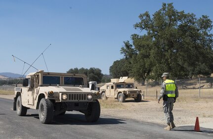 A U.S. Army Soldier with the 382nd Military Police Detachment from San Diego, approaches a vehicle to check identification at an entry control point at Fort Hunter Liggett, Calif., Aug. 1. The 382nd worked with Fort Hunter Liggett police to maintain law and order and force protection during annual training, July 26 - Aug. 10 and supported WAREX 91-15, “Operation Caucasus Restore.” WAREX 91-15 prepares Reserve and National Guard units with real world and scenario based training, as well as basic Soldier skills during the exercise. (Photo by U.S. Army Staff Sgt. Nazly Confesor, 200th MP Command Public Affairs/Released)