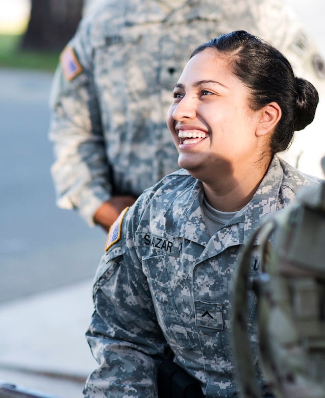 U.S Army Pvt. Jennifer Salazar, military police officer with the 382nd Military Police Detachment from San Diego, Calif., laughs with her fellow MPs before formation at Fort Hunter Liggett, Calif., Aug. 1. Salazar, a Corona, Calif., native, worked with Fort Hunter Liggett police to maintain law and order and force protection during her annual training, July 26 Aug. 10. The 382nd supported WAREX 91-15, “Operation Caucasus Restore.” WAREX 91-15 prepares Reserve and National Guard units with real world and scenario based training, as well as basic Soldier skills during the exercise. (Photo by U.S. Army Staff Sgt. Nazly Confesor, 200th MP Command Public Affairs/Released)