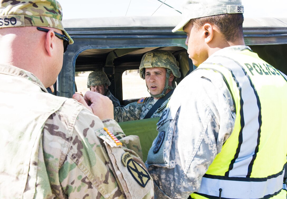 U.S. Army military police officers, with the 382nd Military Police Detachment from San Diego, approach a vehicle to check credentials at an entry control point at Fort Hunter Liggett, Calif., Aug. 3. The 382nd worked with Fort Hunter Liggett police to maintain law and order and force protection during their annual training, July 26 - Aug. 10 and supported WAREX 91-15, “Operation Caucasus Restore.” WAREX 91-15 prepares Reserve and National Guard units with real world and scenario based training, as well as basic Soldier skills during the exercise. (Photo by U.S. Army Staff Sgt. Nazly Confesor, 200th MP Command Public Affairs/Released)