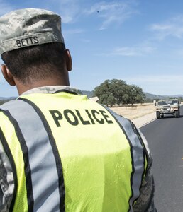 U.S. Army Spc. Kevin Betts, with the 491st Military Police Company, Riverside, Calif., directs traffic at Fort Hunter Liggett, Calif., Aug. 3. Betts, a Riverside, Calif., native, worked with Fort Hunter Liggett police to maintain law and order and force protection during his annual training, July 26- Aug. 10. The 382nd supported WAREX 91-15, “Operation Caucasus Restore.” WAREX 91-15 prepares Reserve and National Guard units with real world and scenario based training, as well as basic Soldier skills during the exercise. (Photo by U.S. Army Staff Sgt. Nazly Confesor, 200th MP Command Public Affairs/Released)