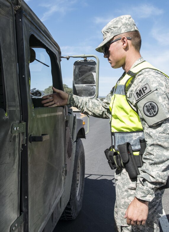 U.S. Army Pfc. Dalton Potts, with the 382nd Military Police Detachment, checks credentials at an entry control point at Fort Hunter Liggett, Calif., Aug. 3. Potts, a Corona, Calif., native, worked with Fort Hunter Liggett police to maintain law and order and force protection during his annual training, July 26 - Aug. 10. The 382nd supported WAREX 91-15, “Operation Caucasus Restore.” WAREX 91-15 prepares Reserve and National Guard units with real world and scenario based training, as well as basic Soldier skills during the exercise.
(Photo by U.S. Army Staff Sgt. Nazly Confesor, 200th MP Command Public Affairs/Released)
