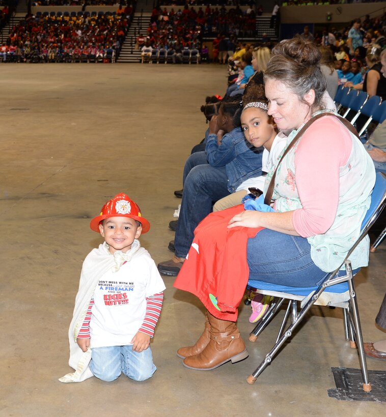 One of the youngest spectators attending the city’s 21st annual Fire Safety Show dons his firefighter’s head gear, T-shirt and cape at Albany’s James H. Gray Civic Center, Oct 7. The little superhero was one of several hundred children, teachers, parents and safety officials, who poured into the Civic Center to participate in the Fire Prevention Week activities.
