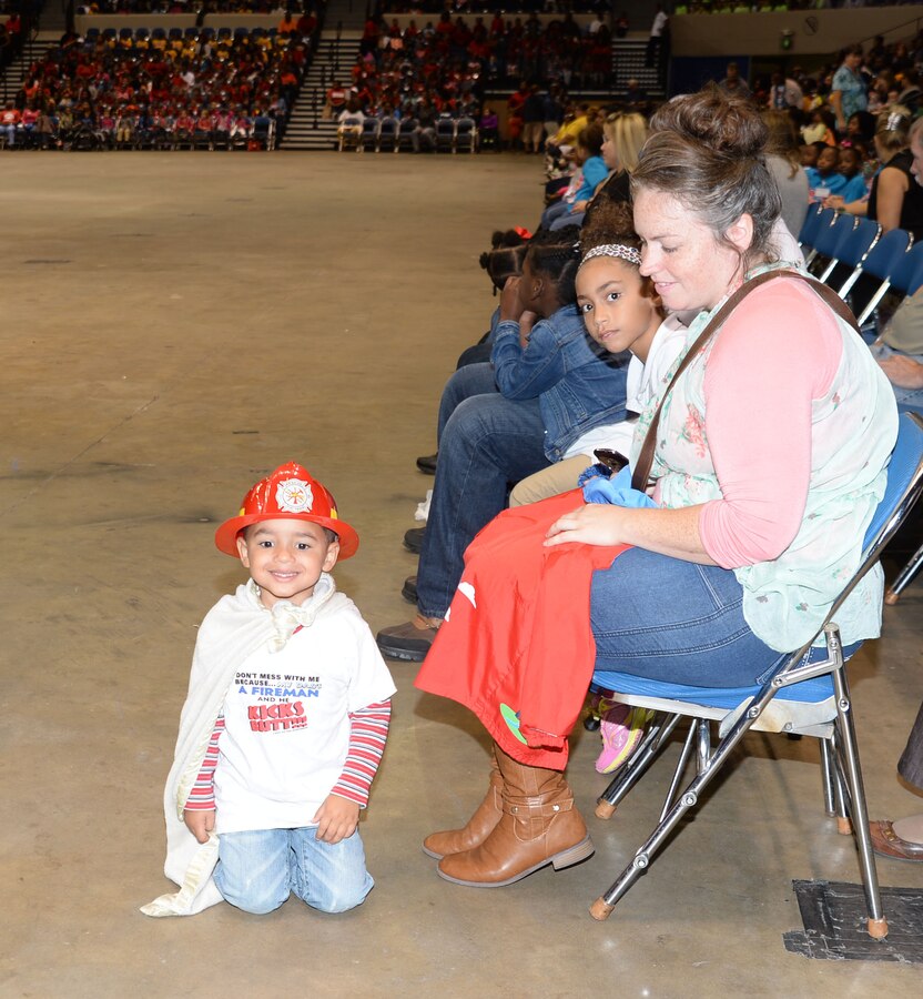 One of the youngest spectators attending the city’s 21st annual Fire Safety Show dons his firefighter’s head gear, T-shirt and cape at Albany’s James H. Gray Civic Center, Oct 7. The little superhero was one of several hundred children, teachers, parents and safety officials, who poured into the Civic Center to participate in the Fire Prevention Week activities.
