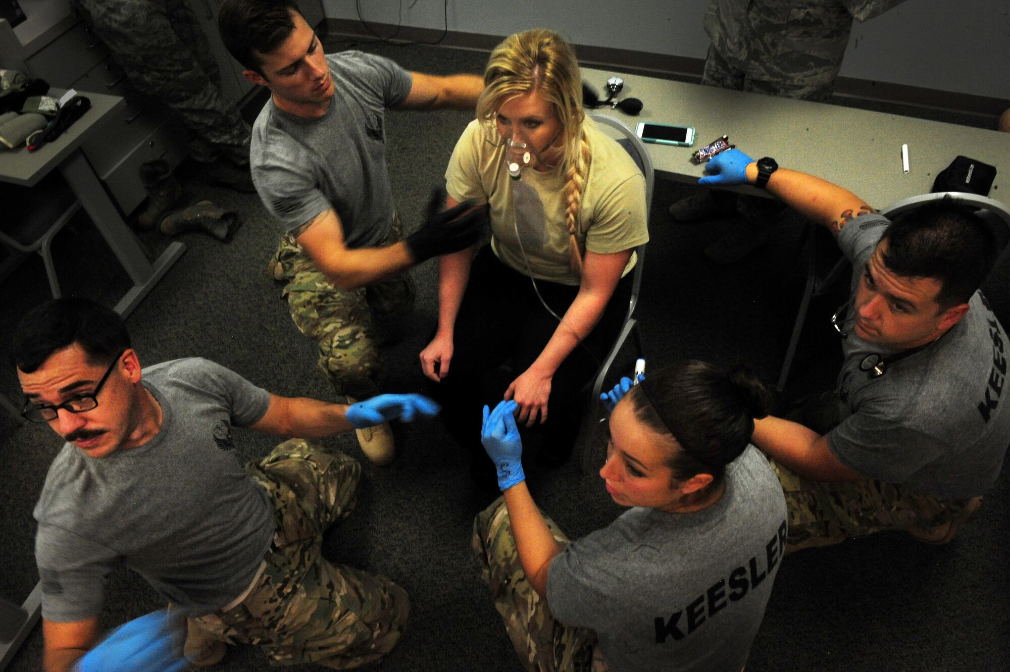 Emergency medical technicians from Keesler Air Force Base, Miss. treat a patient with anaphylactic shock during a scenario of the EMT Rodeo, Sept. 17, 2015, at Cannon Air Force Base, N.M.. Twenty-one teams of elite EMTs from 22 installations across the Air Force convened at Cannon for four days of innovative, high-octane competition Sept. 16-19. Throughout the rodeo teams were required to execute their lifesaving mission under the critical eye of expert evaluators, demonstrating accurate technique and effective implementation. (U.S. Air Force photo/Tech. Sgt. Manuel J. Martinez)