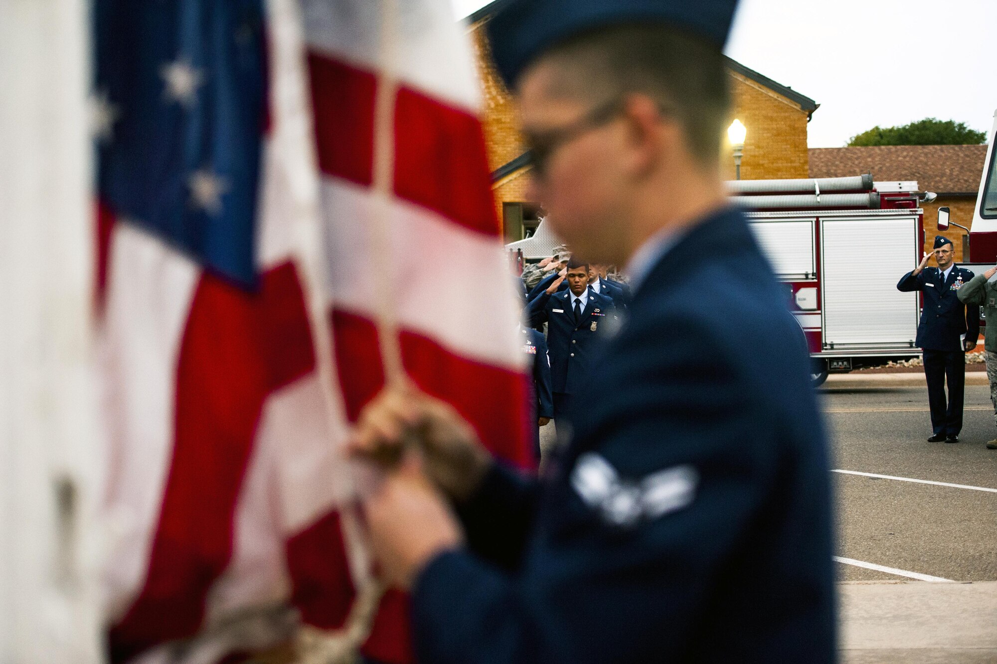 Cannon firefighters assigned to the 27th Special Operations Civil Engineering Squadron, salute as the U.S. Flag is raised to half-staff during a ceremony dedicated to the fallen fiirefighters, Oct. 04, 2015 at Cannon Air Force Base, N.M. The ceremony was in observance of Bells Across America, a day dedicated to paying tribute to fellow fiirefighters who gave their life in the service others. (U.S. Air Force photo/Tech. Sgt. Manuel J. Martinez)