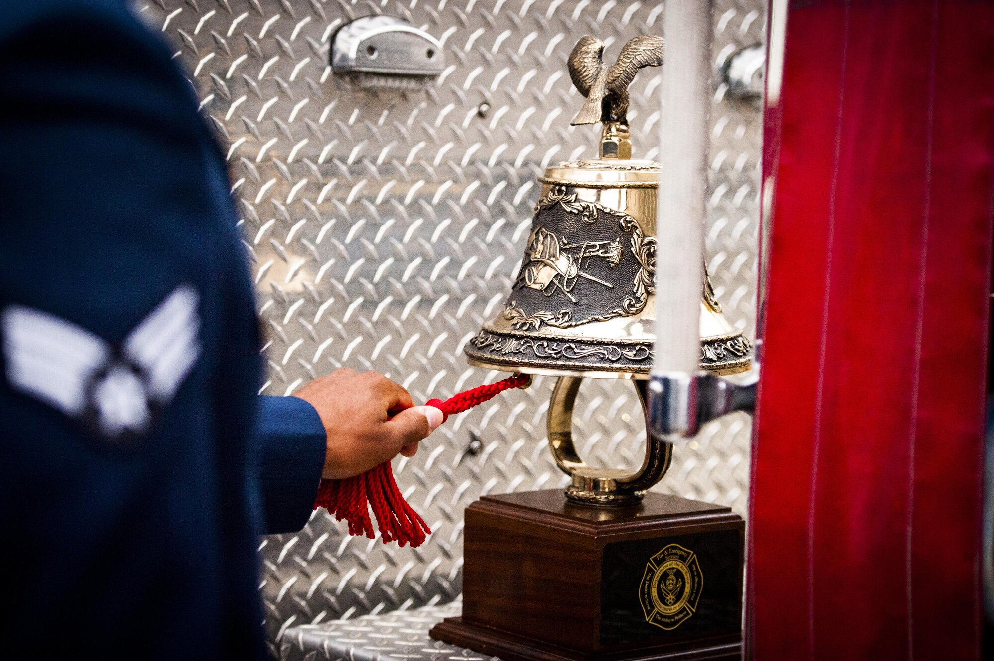 A Cannon firefighter assigned to the 27th Special Operations Civil Engineering Squadron, rings a symbolic bell during a ceremony dedicated to the fallen firefighters, Oct. 04, 2015 at Cannon Air Force Base, N.M. The ceremony was in observance of Bells Across America, a day dedicated to paying tribute to fellow firefighters who gave their life in the service of others. (U.S. Air Force photo/Tech. Sgt. Manuel J. Martinez)