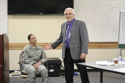 Larry Maxwell, a U.S. Army Military Police School instructor based at Fort Leonard Wood, Mo., introduces Capt. Brandi Thorpe the commander of Headquarters and Headquarters Detachment 15th Military Police Brigade at Fort Leavenworth, Kan. Thorpe is speaking about her personal experiences as a domestic violence victim as part of the Domestic Violence Intervention Training at the Federal Law Enforcement Training Center in Charleston, S.C., during Guardian Shield 2015. Guardian Shield is an annual training event for Army Reserve CID agents.