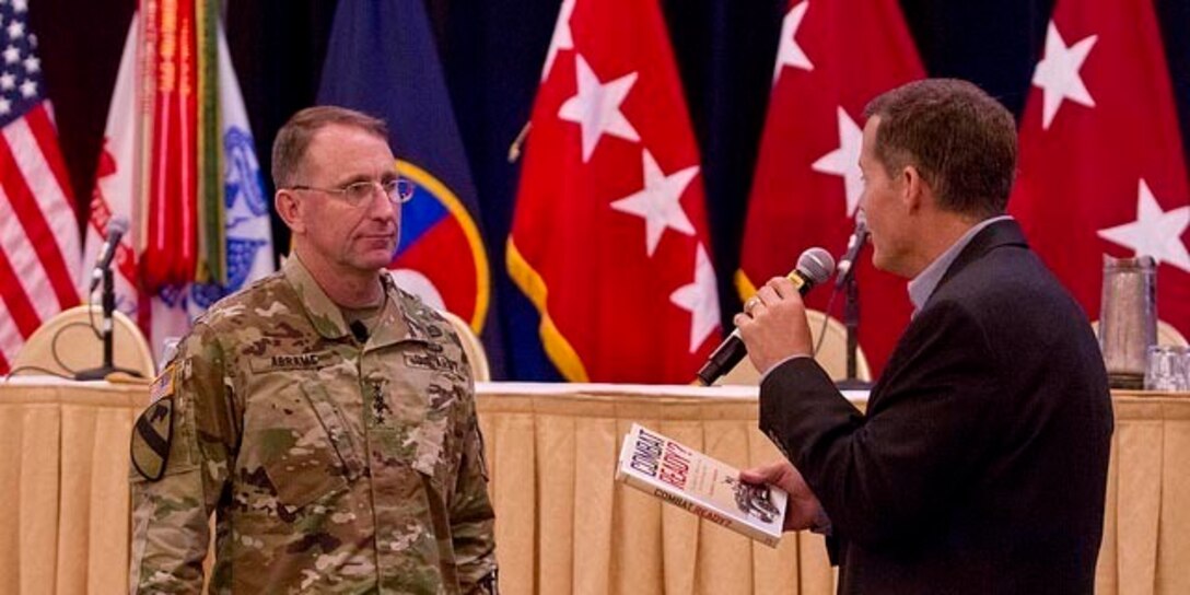 Gen. Robert Abrams, commander of Forces Command, listens as Lt. Gen. Jeffrey Talley, commander of the U.S. Army Reserve, speaks prior to giving him a gift during the U.S. Army Reserve Commander's Conference in Alexandria, Va., Sept. 15. The purpose of the conference was to give commanders an understand of future plans for the the U.S. Army and its Reserve component.
