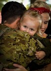 An Air Commando embraces his loved ones during Operation Homecoming at the Deployment Control Center on Hurlburt Field, Fla., Oct. 7, 2015. Families and friends of 59 Air Commandos gathered to welcome home their loved ones from a deployment overseas. (U.S. Air Force photos by Airman Kai White/Released)