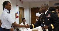Maj. Gen. Phillip M. Churn, the commanding general for the 200th Military Police Command, shakes the hand of Air Force ROTC cadet during the Student Leadership Conference at the Howard University School of Law in Washington, Aug. 29, 2015.  The conference focused on challenging graduate and undergraduate students to become leaders and change agents in society, Maj. Gen. Churn delivered the closing address at the ceremony.