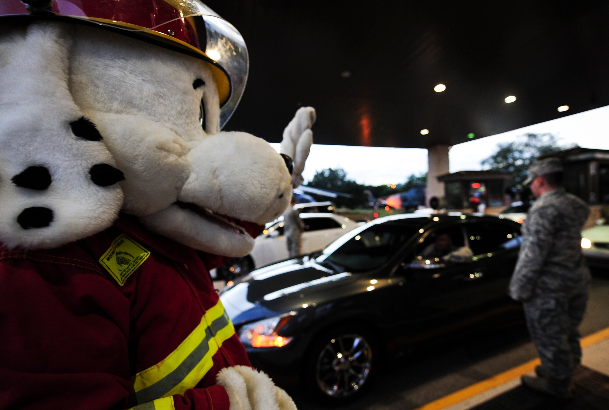 Sparky the Fire Dog, National Fire Prevention Association spokesdog, greets Airmen entering base during Fire Prevention Week at Hurlburt Field, Fla., Oct. 5, 2015. Sparky the Fire Dog and Airmen with the Hurlburt Field Fire Department greet Airmen on base, visited Child Development Centers, the base library and other locations around base throughout the week to educate and raise awareness about fire prevention. This year’s theme is “Hear the BEEP, where you SLEEP: Every Bedroom Needs A Working Smoke Alarm!” Fire Prevention Week will conclude with a fire muster challenge open to Airmen around base, Oct. 9. (U.S. Air Force photo by Senior Airman Meagan Schutter)