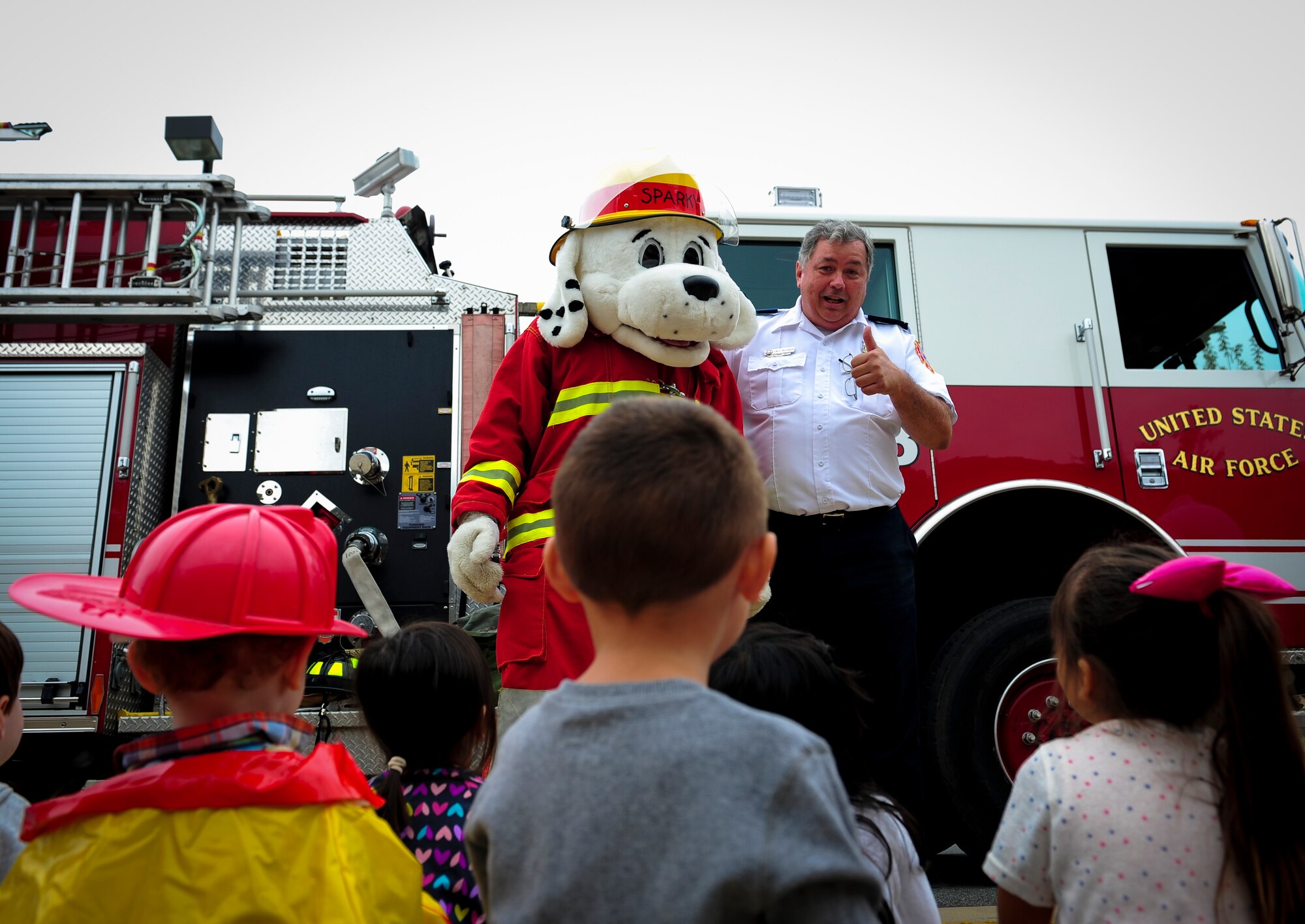 Sparky the Fire Dog, National Fire Prevention Association spokesdog, and Fred Richards, 1st Special Operations Civil Engineer Squadron fire prevention inspector, teach children at the Child Development Center West how to prevent fires during Fire Prevention Week on Hurlburt Field, Fla., Oct. 5, 2015. Sparky the Fire Dog and Airmen with the Hurlburt Field Fire Department greet Airmen on base, visited Child Development Centers, the base library and other locations around base throughout the week to educate and raise awareness about fire prevention. This year’s theme is “Hear the BEEP, where you SLEEP: Every Bedroom Needs A Working Smoke Alarm!” Fire Prevention Week will conclude with a fire muster challenge open to Airmen around base, Oct. 9. (U.S. Air Force photo by Senior Airman Meagan Schutter)