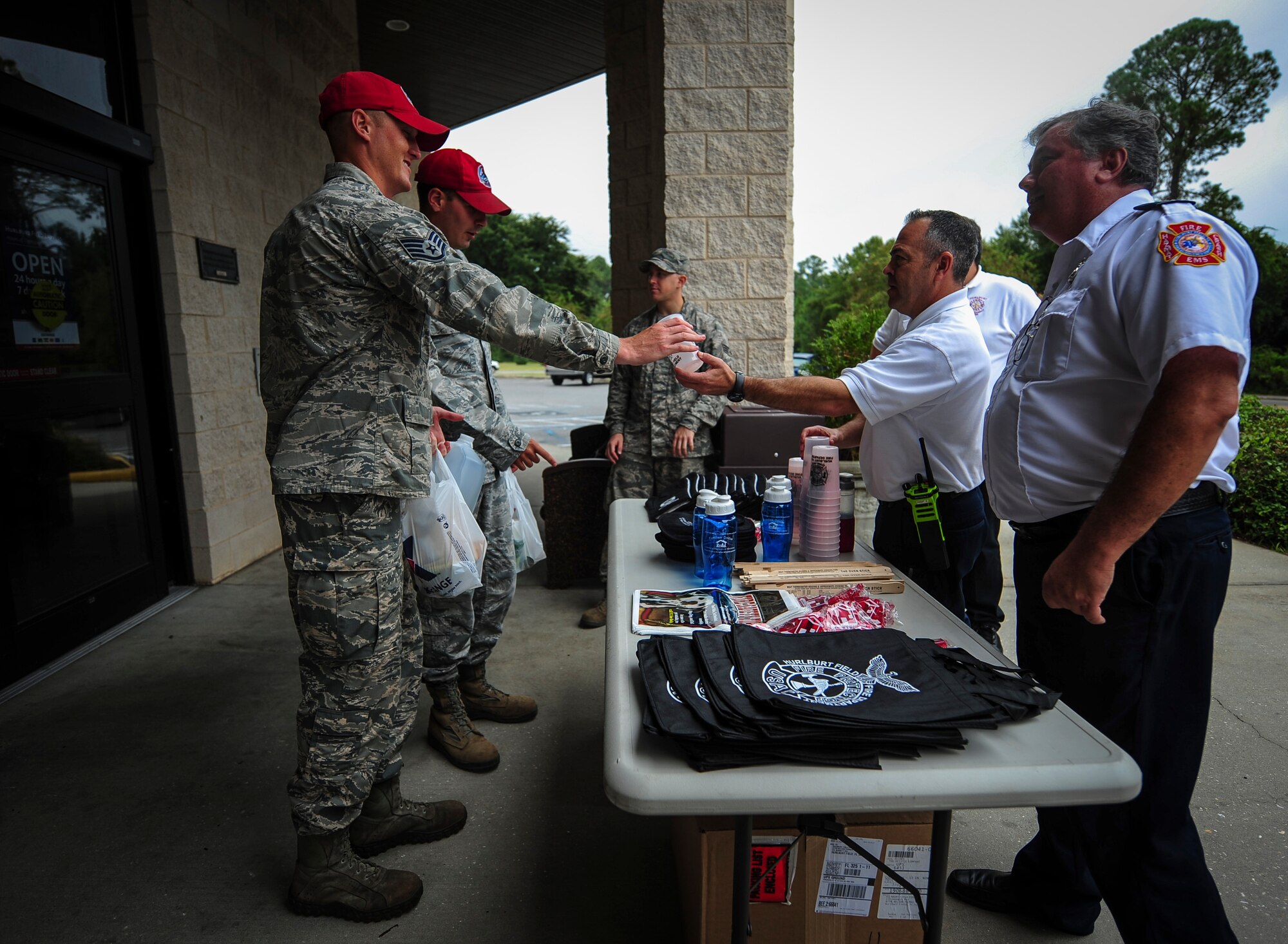 Airmen assigned to the 823rd Red Horse Squadron speak with Hurlburt Field Fire Department fire inspectors during Fire Prevention Week at the Shoppette on Hurlburt Field, Fla., Oct. 5, 2015. Sparky the Fire Dog and Airmen with the Hurlburt Field Fire Department greet Airmen on base, visited Child Development Centers, the base library and other locations around base throughout the week to educate and raise awareness about fire prevention. This year’s theme is “Hear the BEEP, where you SLEEP: Every Bedroom Needs A Working Smoke Alarm!” Fire Prevention Week will conclude with a fire muster challenge open to Airmen around base, Oct. 9. (U.S. Air Force photo by Senior Airman Meagan Schutter)