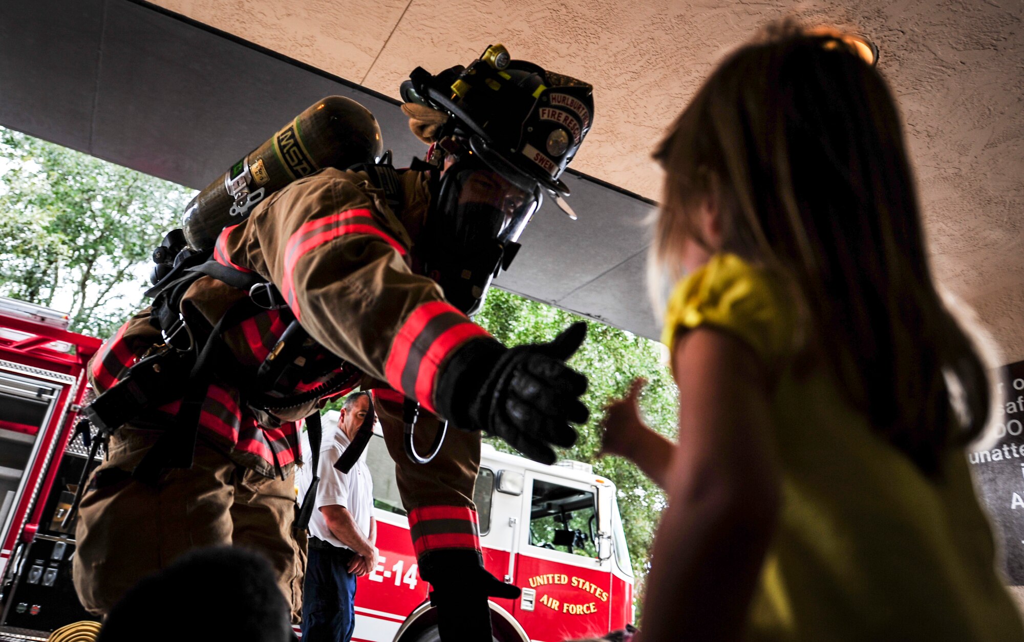 Airman 1st Class Chaz Swem, 1st Special Operations Civil Engineer Squadron firefighter, gives a child a high-five during Fire Prevention Week at the Child Development Center Main on Hurlburt Field, Fla., Oct. 6, 2015. Sparky the Fire Dog and Airmen with the Hurlburt Field Fire Department greet Airmen on base, visited Child Development Centers, the base library and other locations around base throughout the week to educate and raise awareness about fire prevention. This year’s theme is “Hear the BEEP, where you SLEEP: Every Bedroom Needs A Working Smoke Alarm!” Fire Prevention Week will conclude with a fire muster challenge open to Airmen around base, Oct. 9. (U.S. Air Force photo by Senior Airman Meagan Schutter)