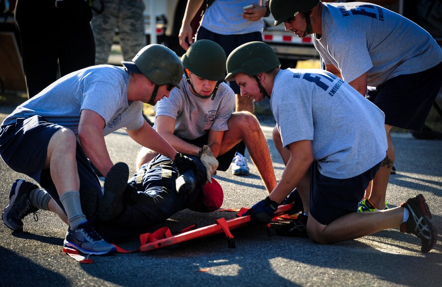 Fire protection members with the 1st Special Operations Civil Engineer Squadron demonstrate how to strap down a dummy during this year’s Fire Prevention Week fire muster challenge on Hurlburt Field, Fla., Oct. 8, 2015. Sparky the Fire Dog, National Fire Prevention Association spokesdog, and Airmen with the Hurlburt Field Fire Department welcomed Airmen on base, visited Child Development Centers, the base library and other locations around base throughout the week to educate and raise awareness about fire prevention. This year’s theme is “Hear the BEEP, where you SLEEP: Every Bedroom Needs A Working Smoke Alarm!” Fire Prevention Week concluded with a fire muster challenge that was open to Hurlburt Airmen. (U.S. Air Force photo by Senior Airman Meagan Schutter)