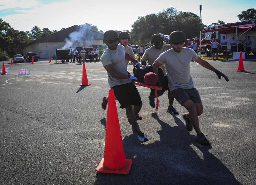 Chief Master Sgt. Cory Olson, 1st Special Operations Squadron command chief, and command chief staff participate in Fire Prevention Week’s fire muster challenge on Hurlburt Field, Fla., Oct. 8, 2015. Sparky the Fire Dog, National Fire Prevention Association spokesdog, and Airmen with the Hurlburt Field Fire Department welcomed Airmen on base, visited Child Development Centers, the base library and other locations around base throughout the week to educate and raise awareness about fire prevention. This year’s theme is “Hear the BEEP, where you SLEEP: Every Bedroom Needs A Working Smoke Alarm!” Fire Prevention Week concluded with a fire muster challenge that was open to Hurlburt Airmen. (U.S. Air Force photo by Senior Airman Meagan Schutter)