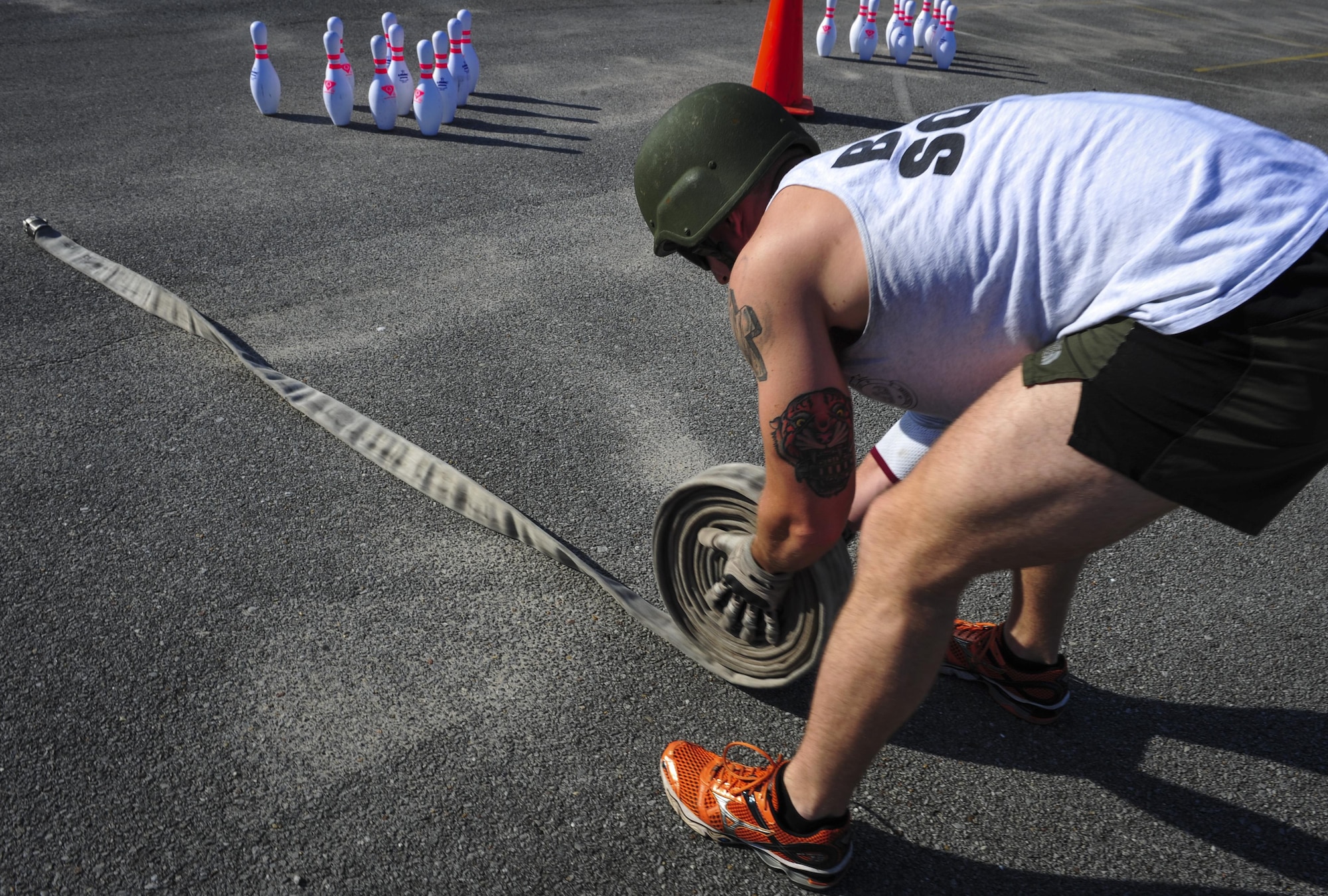 Airman 1st Class John Nipp, 1st Special Operations Squadron explosive ordnance disposal apprentice, rolls a fire hose during Fire Prevention Week’s fire muster challenge on Hurlburt Field, Fla., Oct. 8, 2015. Sparky the Fire Dog, National Fire Prevention Association spokesdog, and Airmen with the Hurlburt Field Fire Department welcomed Airmen on base, visited Child Development Centers, the base library and other locations around base throughout the week to educate and raise awareness about fire prevention. This year’s theme is “Hear the BEEP, where you SLEEP: Every Bedroom Needs A Working Smoke Alarm!” Fire Prevention Week concluded with a fire muster challenge that was open to Hurlburt Airmen. (U.S. Air Force photo by Senior Airman Meagan Schutter)
