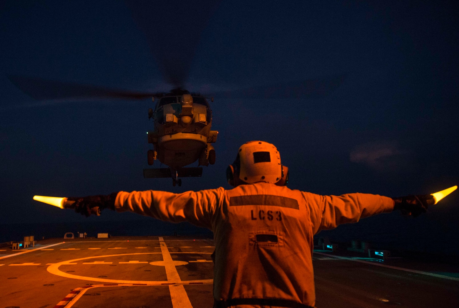 150930-N-MK881-458 BAY OF BENGAL (Sept. 30, 2015) Boatswain's Mate 2nd Class Manuel Gallegos, assigned to the littoral combat ship USS Fort Worth (LCS 3), directs an MH-60R Sea Hawk helicopter attached to Helicopter Maritime Strike Squadron (HSM) 35 during deck landing exercises as part of Cooperation Afloat Readiness and Training (CARAT) Bangladesh 2015. CARAT is an annual, bilateral exercise series with the U.S. Navy, U.S. Marine Corps and the armed forces of nine partner nations. (U.S. Navy photo by Mass Communication Specialist 2nd Class Joe Bishop/Released)