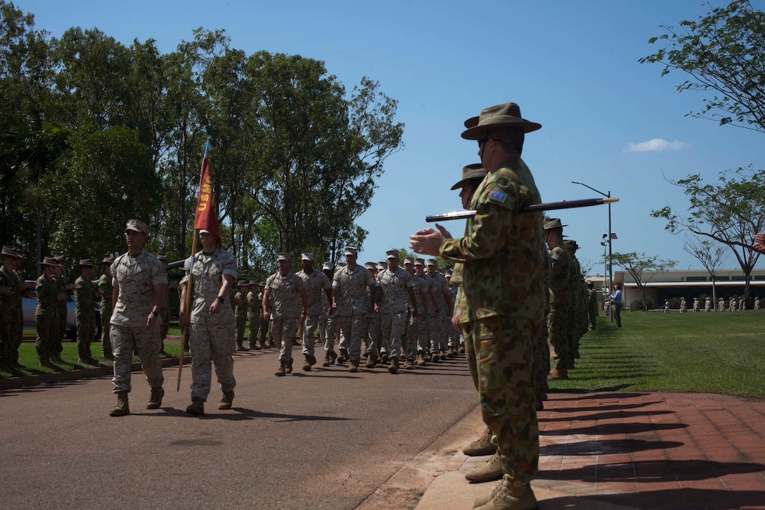 U.S. Marines with 1st Battalion, 4th Marine Regiment, Marine Rotational Force - Darwin march in formation Oct. 5 during a farewell ceremony hosted by 1st Brigade, Australian Army, at Robertson Barracks, Northern Territory, Australia. U.S. Marine Corps Maj. Gen. Richard Simcock and Australian Brig. Mick Ryan congratulated the Marines on their hard work and the amount of effort they’ve shown throughout their time participating in training exercises, performing community services and immersing in Australian culture. The rotational deployment of U.S. Marines in Australia affords an unprecedented combined training opportunity with our allies and improves interoperability between our forces. Simcock is the commanding general of 3rd Marine Division, III Marine Expeditionary Force and Ryan is the commander of 1 BDE.