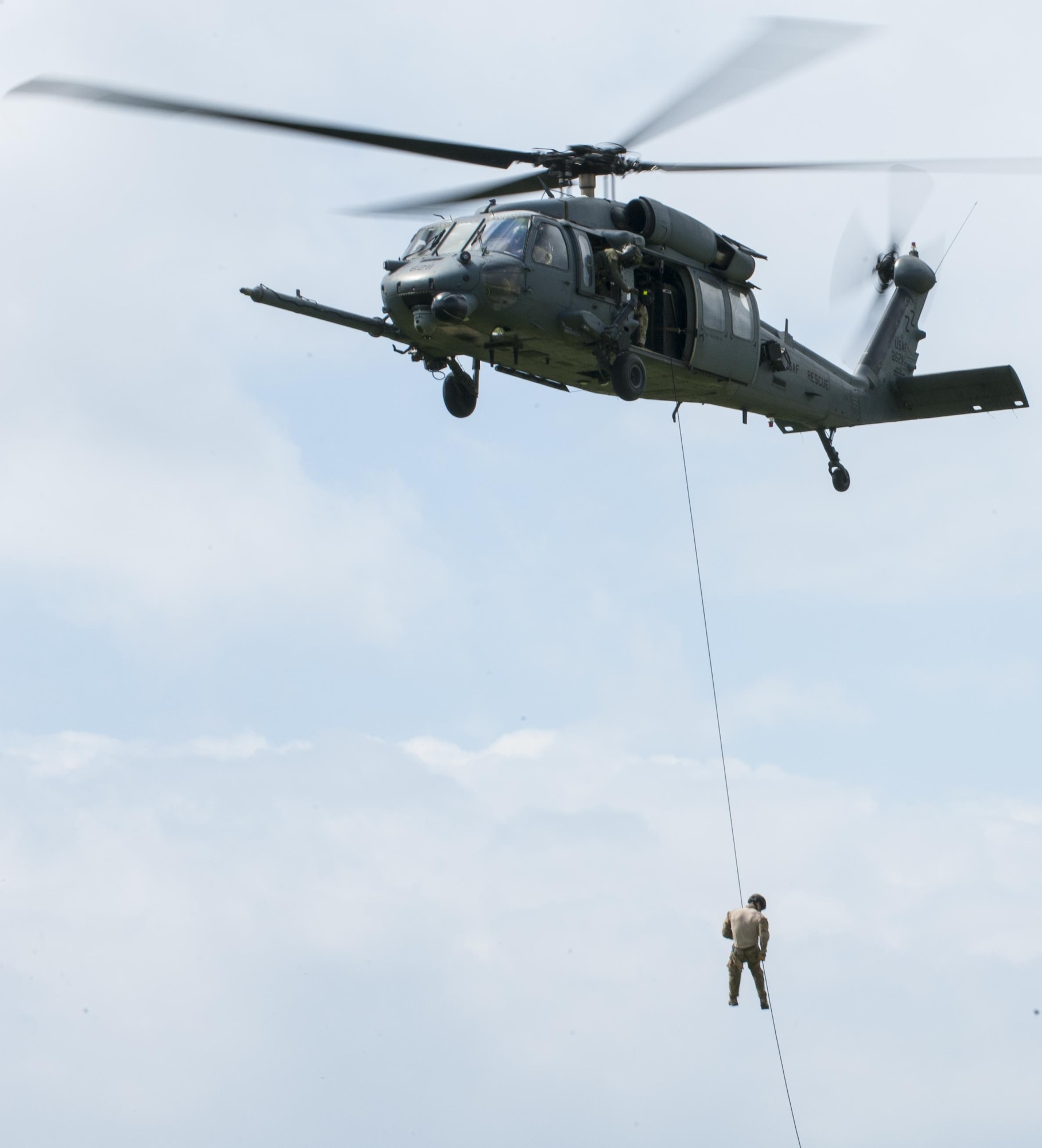 U.S. Air Force pararescuemen zipline from a helicopter October 3, 2015 on Kadena Air Base, Japan. These Airmen are part of a demonstration for Rescuefest, a yearly event that displays the capabilities of the 31st and 33rd rescue squadrons. (U.S. Air Force photo by Airman 1st Class Nicholas Emerick/Released)