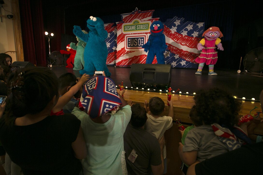 Characters from Sesame Street dance during a live show for service members and their children Sept. 4 at the Camp Foster Community Center. The show, titled “Katie Moves to a New Base,” was designed to help military families dealing with a permanent change of station. The show is part of the Sesame Street and the USO tour experience for military families which provides an entertaining way to help service members and their children cope with the many changes that come with the military lifestyle.
