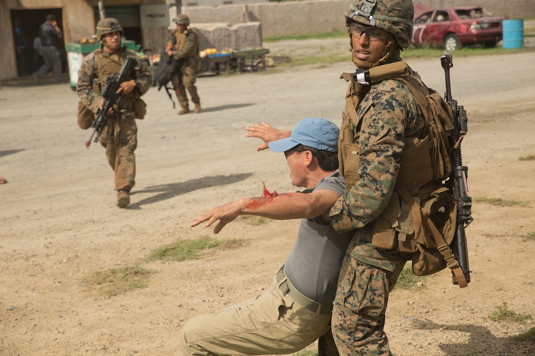 Lance Cpl. Malcolm Johnson, a rifleman with 3rd Battalion, 3rd Marine Regiment, buddy drags a role player to safety after a simulated improvised explosive device detonation while conducting Military Operations in Urban Terrain training at Marine Corps Base Hawaii, Sept. 29, 2015. MOUT training is conducted to teach Marines to capitalize on the strategic or tactical advantages of possession or control of an urban area. (U.S. Marine Corps photo by Lance Cpl. Zachary Orr)