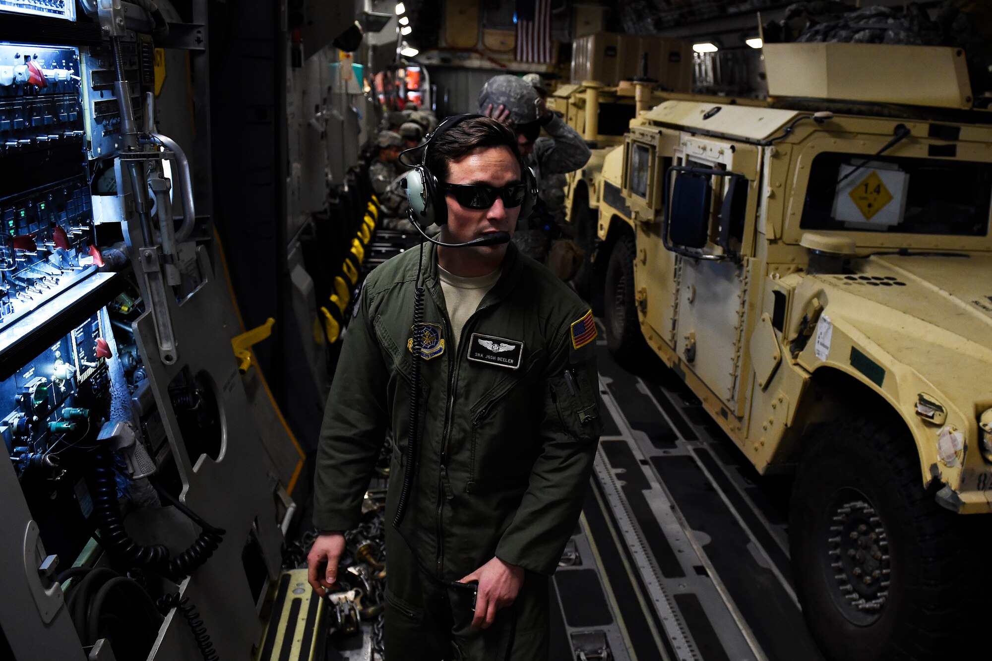 Senior Airman Josh Beeler, 8th Airlift Squadron C-17 Globemaster III loadmaster, prepares to unload Soldiers and Humvees from the 82nd Airborne Division Sept. 27, 2015 at White Sands, N.M., as part of an Emergency Deployment Readiness Exercise. The EDRE was one part of the Network Integration Evaluation 16.1. (U.S. Air Force photo/Staff Sgt. Tim Chacon)