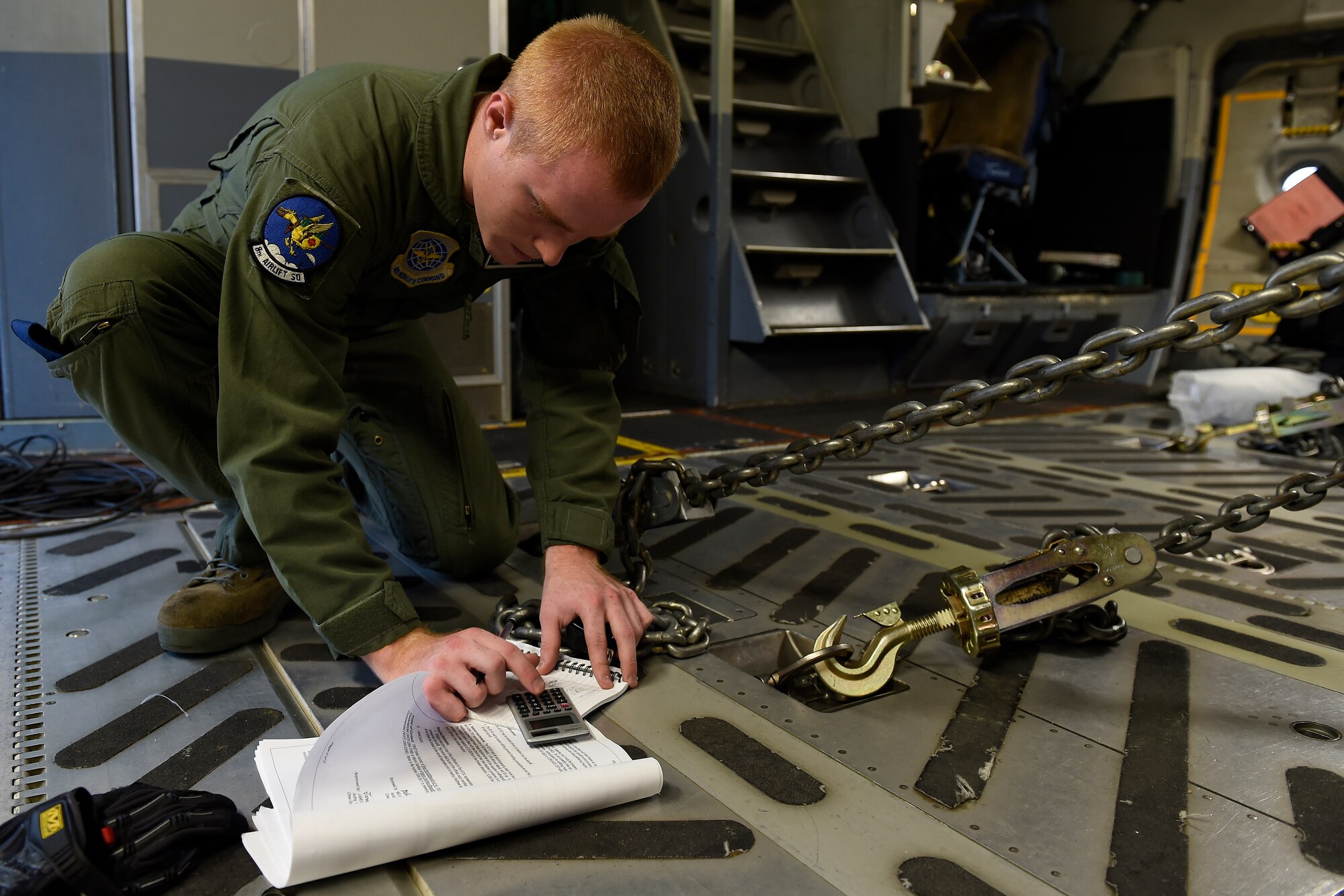 Senior Airman Cody Sellers, 8th Airlift Squadron C-17 Globemaster III loadmaster, secures a Humvee into a C-17 Sept. 27, 2015 at Pope Army Airfield, N.C. The C-17 crew delivered four Humvees and more than 50, 82nd Airborne Division Soldiers from Fort Bragg, N.C., to White Sands, N.M. as part of an Emergency Deployment Readiness Exercise. (U.S. Air Force photo/Staff Sgt. Tim Chacon)