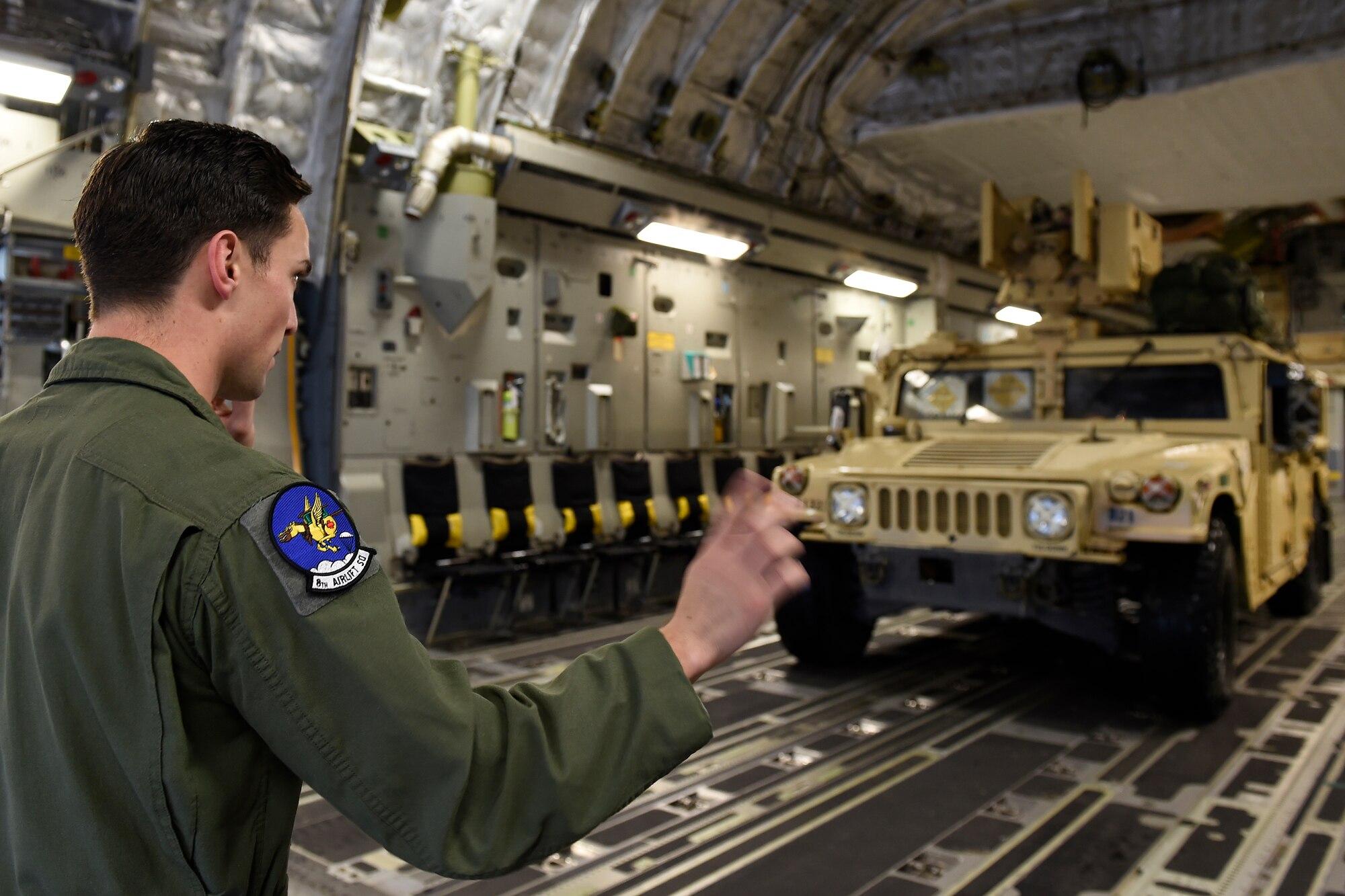 Senior Airman Josh Beeler, 8th Airlift Squadron C-17 Globemaster III loadmaster, loads a Humvee onto a C-17 Sept. 27, 2015 at Pope Army Airfield, N.C. The Humvee was one of four belonging to the 82nd Airborne Division from Fort Bragg, N.C., delivered to White Sands, N.M. as part of an Emergency Deployment Readiness Exercise. (U.S. Air Force photo/Staff Sgt. Tim Chacon)