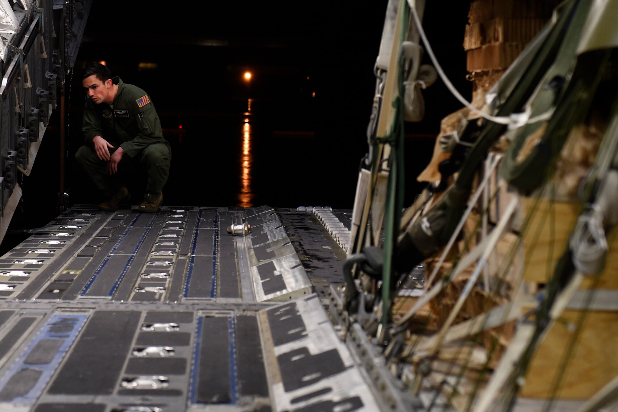 Senior Airman Josh Beeler, 8th Airlift Squadron C-17 Globemaster III loadmaster, loads cargo on to a C-17 Sept. 27, 2015 at Pope Army Airfield, N.C. The cargo was to be air-dropped as part of an Emergency Deployment Readiness Exercise conducted with the 82nd Airborne Division from Fort Bragg, N.C. (U.S. Air Force photo/Staff Sgt. Tim Chacon)