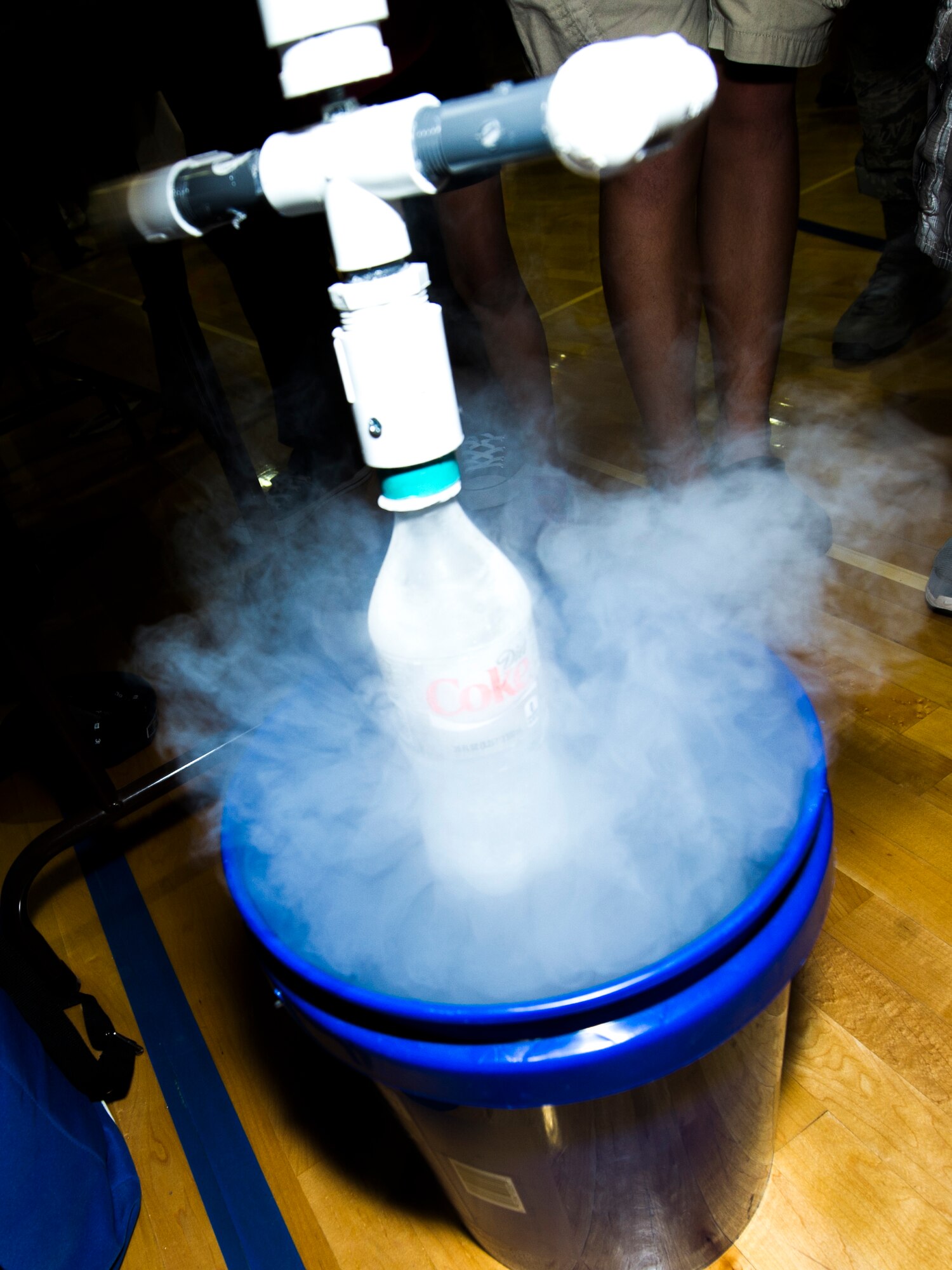 A bottle filled with dry ice is placed in a bucket with water, showing the effects of sublimation during the Science Fair at Holloman Middle School, Oct. 7. Because the temperature of dry ice is so low, when it was placed in the water the temperature difference was as if the water was boiling— making the dry ice turn from a solid to a gas. Various organizations from around Holloman Air Force Base and the city of Alamogordo had presentations to teach Team Holloman about science and technology. (U.S. Air Force photo by Airman 1st Class Emily A. Kenney)    
