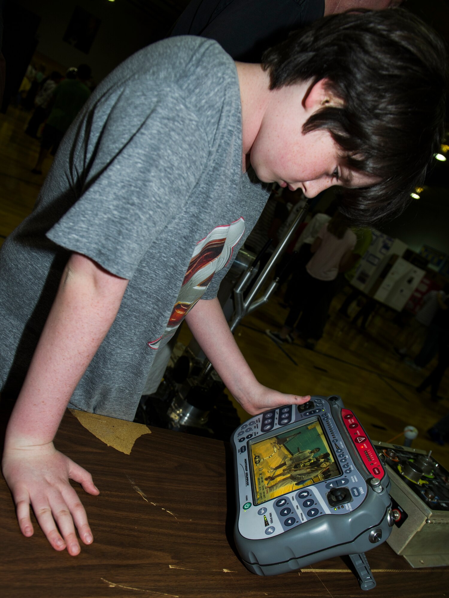 A student from Holloman Middle School uses a control unit to guide an ANDROS HD-1 robot during the Holloman Middle School Science Fair, Oct. 7. Units from Holloman Air Force Base came to the Science Fair to show children the technology that is used to accomplish various missions at Holloman. Students also did experiments of their own and displayed their science projects in the school’s gym. (U.S. Air Force photo by Airman 1st Class Emily A. Kenney)        