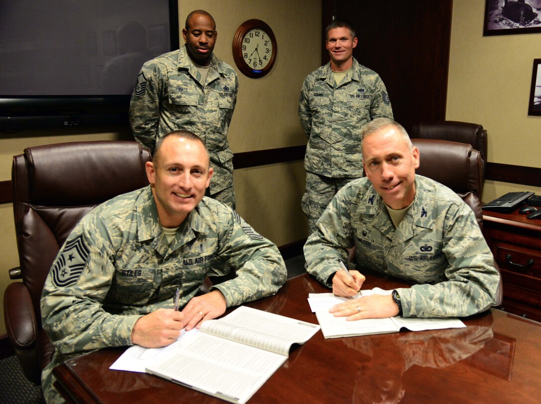 Chief Master Sgt. Thomas Stiles, 341st Missile Wing command chief, left, and Col. Tom Wilcox, 341st Missile Wing commander, right, make the first donations to the Combined Federal Campaign Oct. 8, 2015, at Malmstrom Air Force Base, Mont. The CFC mission is to encourage federal employees to participate in the world’s largest annual workplace charity campaign to make tax-deductible donations to eligible non-profit organizations focused on improving the health, wealth and quality of human life from Oct. 9 through Nov. 9. (U.S. Air Force photo/Airman 1st Class Magen M. Reeves)