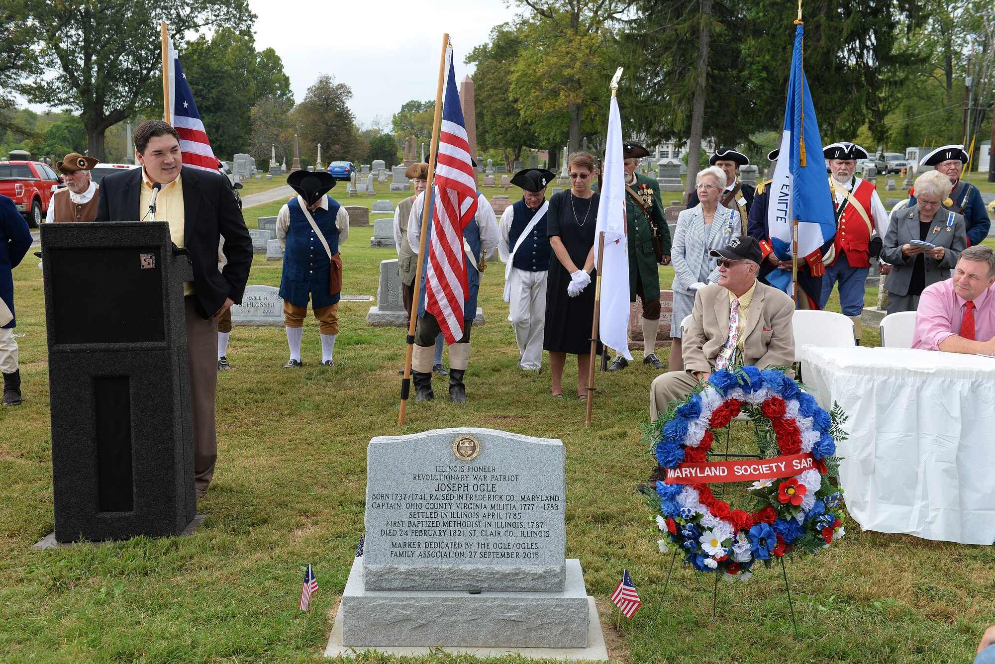 Matt Rice, district director, Belleville, Illinois office, speaks on behalf of Illinois representative Mike Bost at a cenotaph dedication for Capt. Joseph Ogle at the Shiloh Valley Cemetery, Shiloh, Illinois, Sept. 27, 2015. Ogle was an Illinois territory pioneer and Revolutionary War patriot, and Rice thanked the family for working to honor Ogle, and reading the Congressional record read by Mike Bost in the United States House of Representatives. (U.S. Air Force photo by Airman 1st Class Erica Holbert-Siebert)
