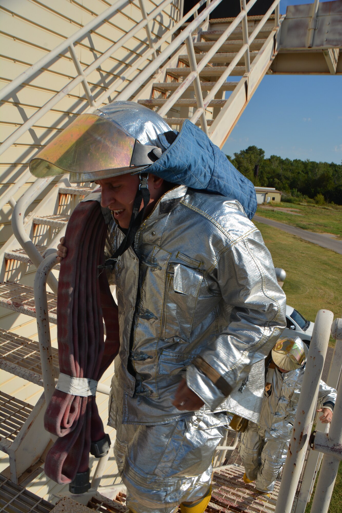 Senior Airman Zachary Mandevill, a firefighter from the 507th Civil Engineer Squadron, carries a hose up the fire training tower during the annual 9/11 fire climb Sept. 13, 2015 at Tinker Air Force Base, Okla. This marks the 6th year that the Reservists have commemorated the victims and workers of 9/11 attacks by climbing the fire training tower for 56 minutes, which is the time it took for the south tower to collapse after being struck by an airliner. (U.S. Air Force photo/Maj. Jon Quinlan)