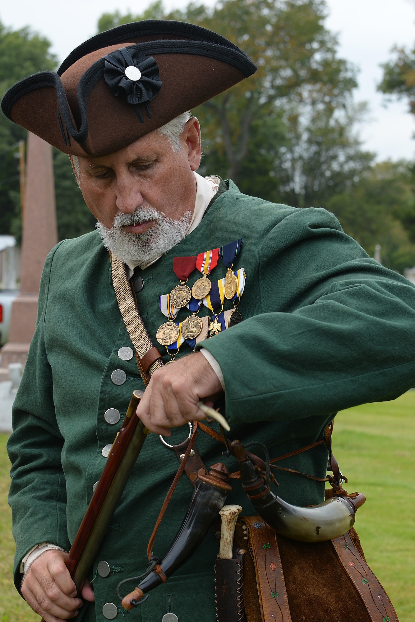A Sons of the American Revolution Color guardsman loads his gunpowder into his musket prior to the dedication of a cenotaph to Capt. Joseph Ogle at the Shiloh Valley Cemetery, Shiloh, Illinois, Sept. 27, 2015. Ogle was an Illinois territory pioneer and Revolutionary War patriot whose efforts included defending Fort Henry, in what is now Wheeling, West Virginia. (U.S. Air Force photo by Airman 1st Class Erica Holbert-Siebert)