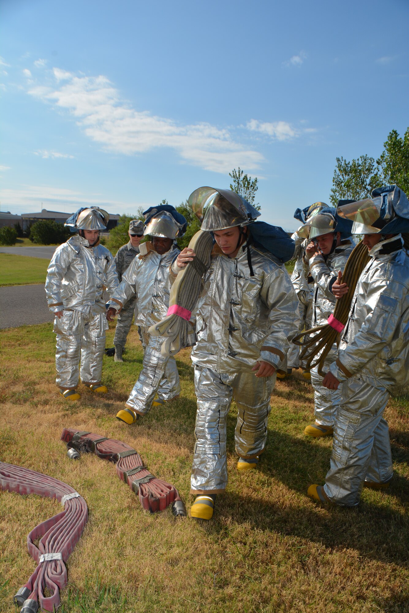 Senior Airman Michael Rowell and fellow firefighters from the 507th Civil Engineer Squadron gear up and carry fire hoses during their annual 9/11 fire climb Sept. 13, 2015 at Tinker Air Force Base, Okla. This marks the 6th year that the Reservists have commemorated the victims and workers of 9/11 attacks by climbing the fire training tower for 56 minutes, which is the time it took for the south tower to collapse after being struck by an airliner. (U.S. Air Force photo/Maj. Jon Quinlan)