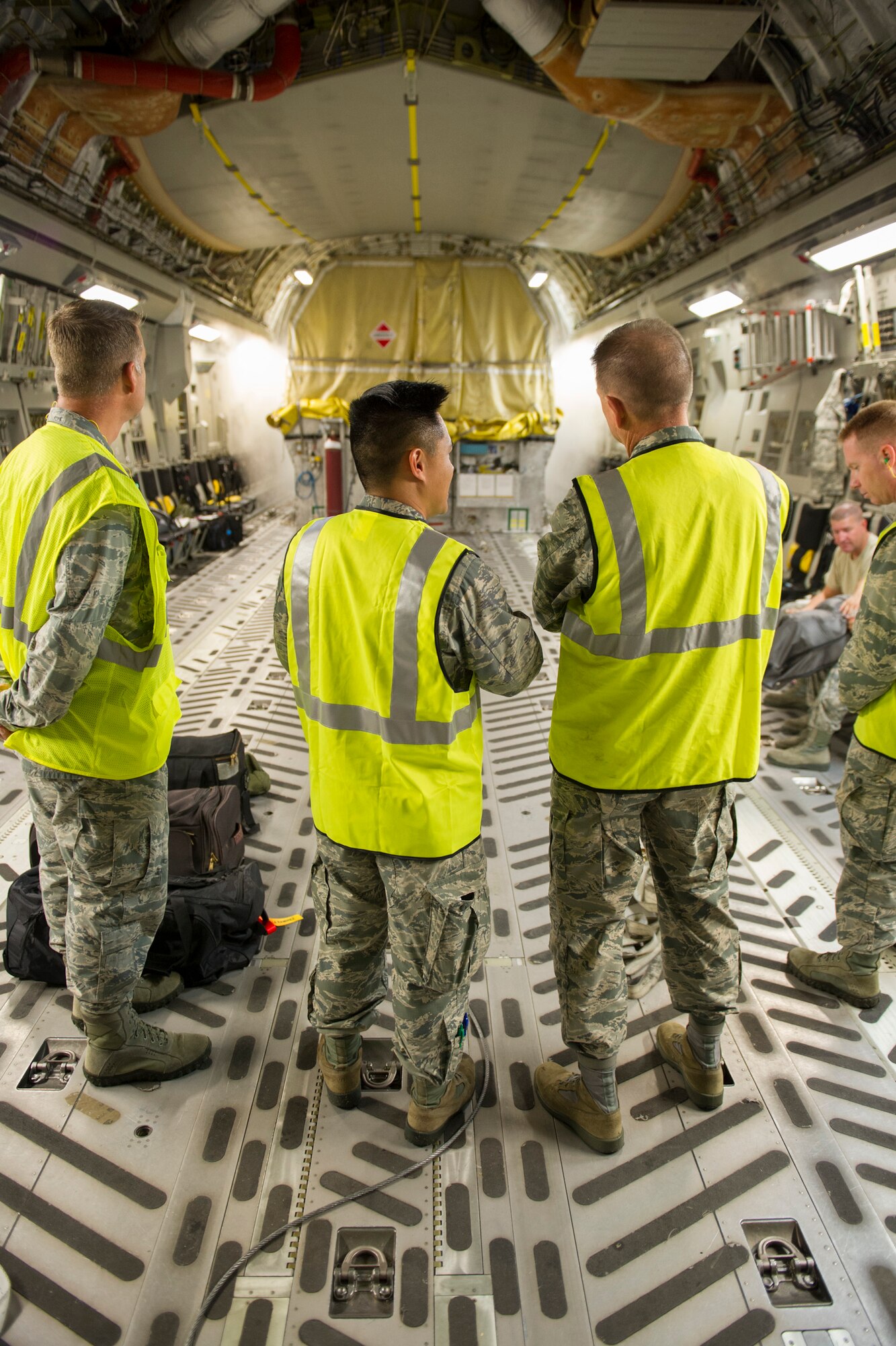 Capt. Trung Nguyen, 45th Launch Support Squadron field program manager, explains his role as the interface between the 45th Space Wing and the Air Force Space and Missile Center for the GPS IIF-12 satellite with Brig. Gen. Wayne Monteith, 45th SW commander, while standing on the loading dock of the Air Force C-17 Globemaster that delivered the last model of the IIF series to Cape Canaveral Air Force Station Oct. 8, 2015. A crowd from the government and industry partnership, who will complete the satellite’s final assembly, gathered on the Cape’s “Skid Strip” to watch the off-loading of the satellite they will prepare to launch aboard a United Launch Alliance rocket in 2016. (U.S. Air Force photo/James Rainier)