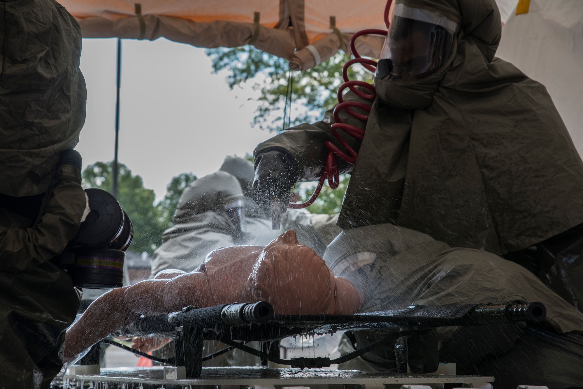Medical Group members decontaminate a test patient, at Scott Air Force Base Medical Clinic, October 1, 2015. The members were able to complete the timed test in a mission capable time frame. (U.S. Air Force photo by Airman Gwendalyn Smith)