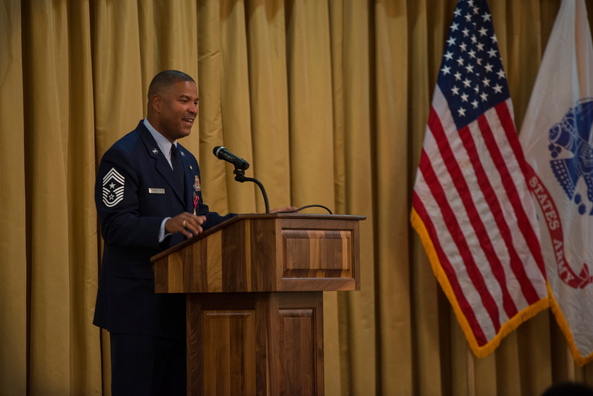 Chief Master Sgt. Phillip Robinson, 87th Air Base Wing command chief, speaks at his retirement ceremony at Tommy B’s Community Activities Center on Joint Base McGuire-Dix-Lakehurst, N.J. Oct. 6, 2015. Robinson retired on his birthday after 30 years of active-duty service in the U.S. Air Force. (U.S. Air Force photo by Airman 1st Class Joshua King/Released)