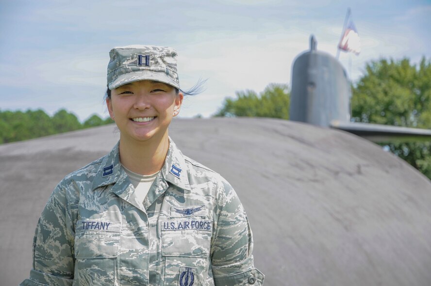 U.S. Air Force Capt. Jessica Tiffany poses for a photo at Naval Submarine Base Kings Bay, Ga., Sept. 22, 2015. Tiffany is one of the first four Air Force intercontinental ballistic missile (ICBM) officers selected to serve with U.S. Navy Submarine Forces (SUBFOR) ballistic missile submarine (SSBN) units through the Striker Trident nuclear officer exchange program. In May, she left the 341st Missile Wing at Malmstrom Air Force Base, Mont., to begin a three-year assignment as a strategic targeting assistant in the strategic forces, nuclear weapons and force protection directorate at Commander, Submarine Force, U.S. Pacific Fleet (COMSUBPAC), Joint Base Pearl Harbor-Hickam, Hawaii. The Striker Trident exchange program enables Navy and Air Force nuclear-qualified officers to gain an expanded view of the nuclear triad, as well as each leg’s respective role in U.S. Strategic Command’s (USSTRATCOM) strategic deterrence mission. (U.S. Navy photo by Mass Communication Specialist Seaman Jamal McNeill)