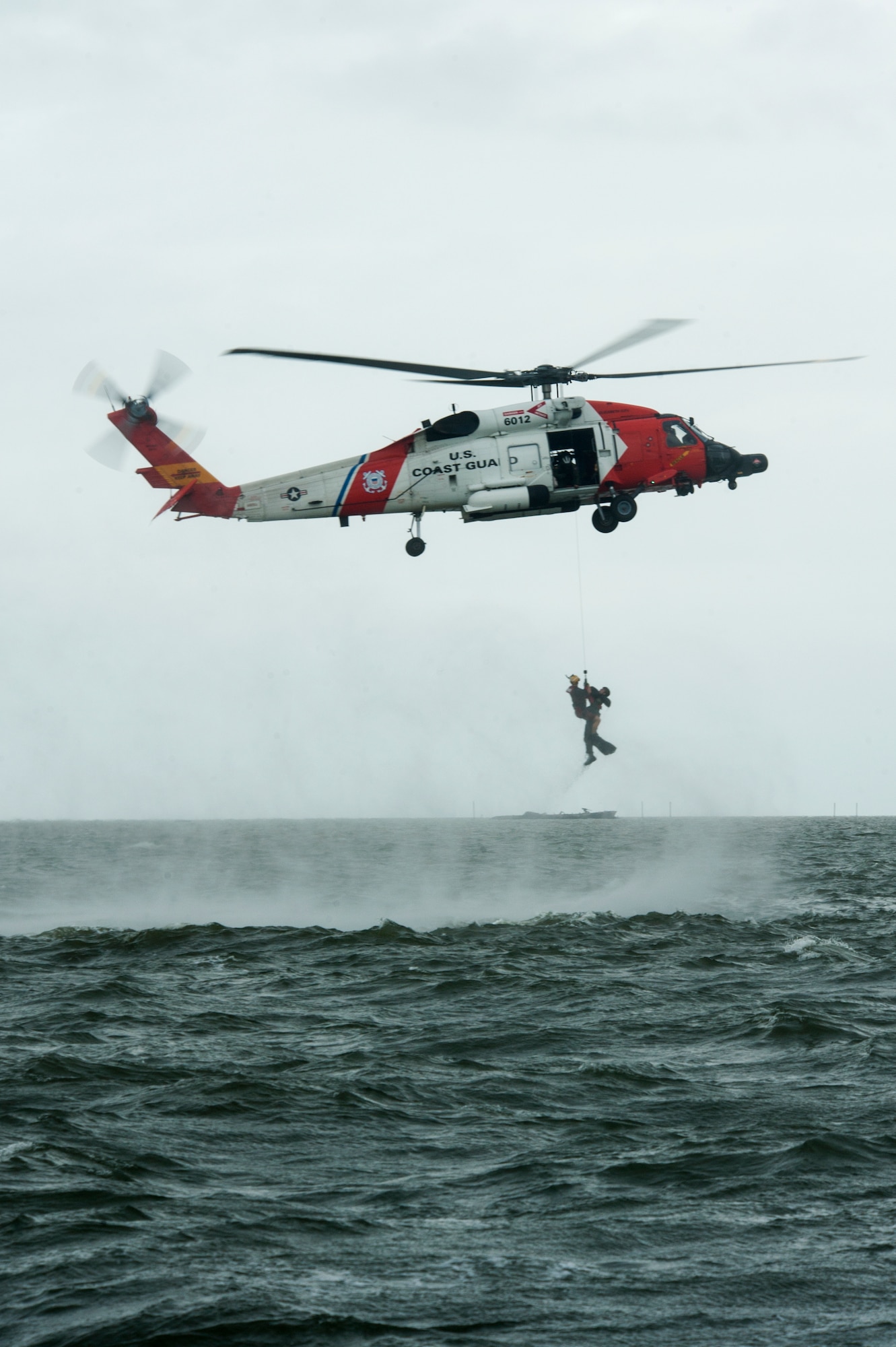 A rescue swimmer, from Coast Guard Air Station Elizabeth City, North Carolina, lifts Capt. Alex Arbuckle, 334th Fighter Squadron pilot, out of the water into a HH-60J Jayhawk during a search and rescue training mission, Sept. 24, 2015, off the coast of North Carolina. Airmen from Seymour Johnson Air Force Base, North Carolina and sailors from Coast Guard Air Station Elizabeth City and Coast Guard Station Hobucken, North Carolina worked together to locate and rescue a simulated ejected pilot and weapons systems officer as part of a joint training exercise. (U.S. Air Force photo/Airman Shawna L. Keyes)  