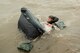 Capt. Alex Arbuckle, 334th Fighter Squadron pilot, reaches for his life raft during a search and rescue training exercise, Sept. 24, 2015, off the coast of North Carolina. During the scenario, two aircrew members from the 334th FS were placed in the water to perform survival techniques while coordinating rescue from the U.S. Coast Guard. (U.S. Air Force photo/Airman Shawna L. Keyes)