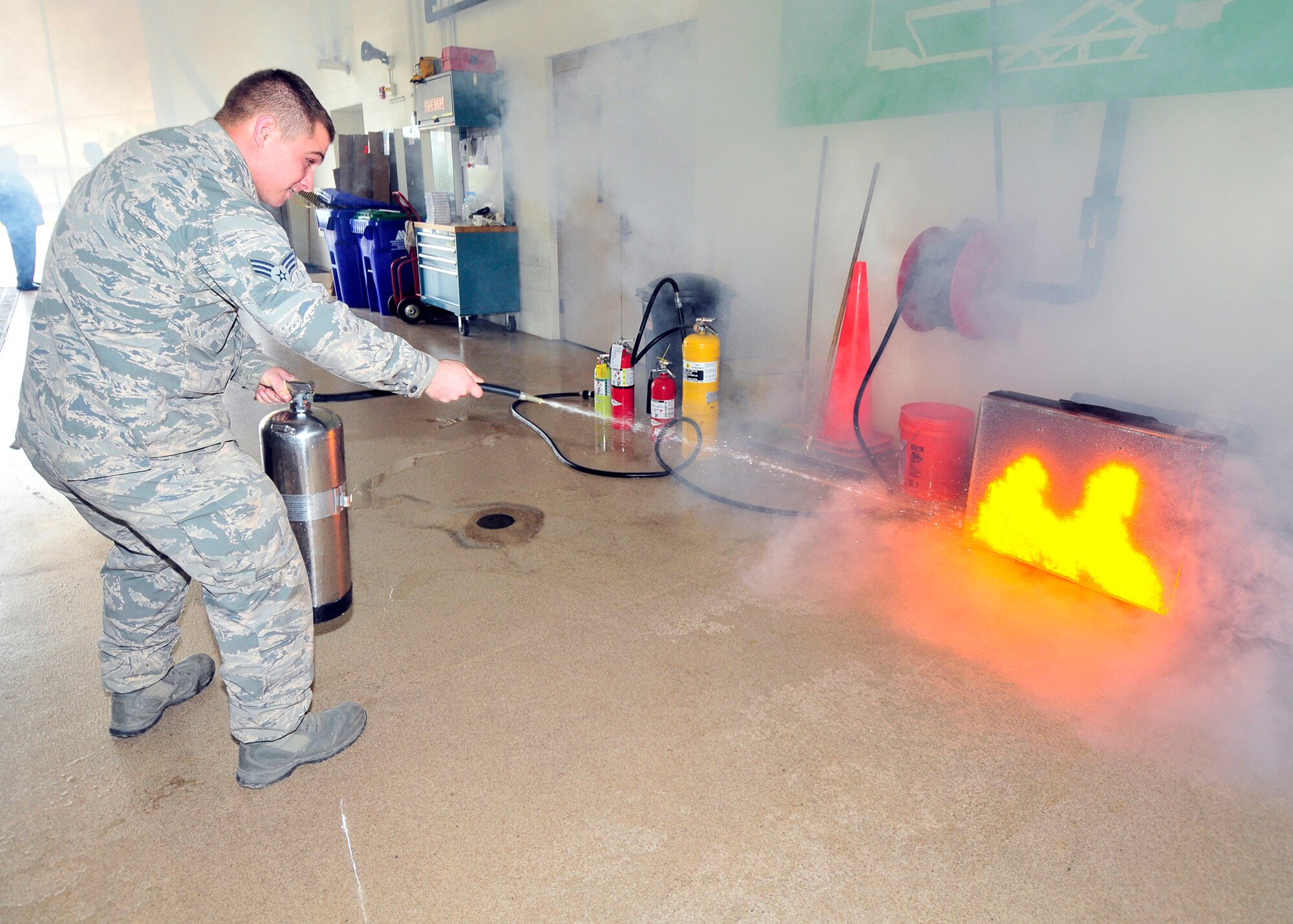 Senior Airman Irvin Buck, Heavy Machinery Operator, 914th CES practices putting out a simulated fire on the new Attack Digital Fire Training System at the Niagara Falls Air Reserve Station, New York on October 7, 2015. National Fire Prevention Week runs this year from October 4 – 10. (U. S. Air Force photo by Peter Borys)