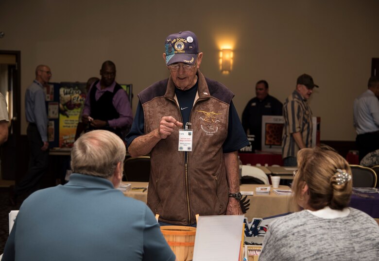Retired Chief Master Sgt. Victor Hugo, former 446th Military Air Wing command chief at McChord Air Force Base, Wash., converses with vendors at the Health and Wellness Fair during Retiree Appreciation day Oct. 2, 2015, at Fairchild Air Force Base, Wash. Hugo served four years as active duty and 27 years in the Air Force Reserve. (U.S. Air Force photo/Airman 1st Class Sean Campbell)